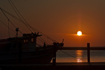 Fishing boat tied to the dock on the Apalachicola River at sunrise