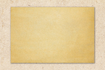 Recycled brown paper on natural chipboard background.