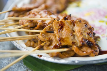 Roasting pork skewers on dish