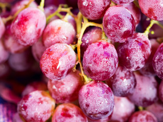 Fresh red wine grapes or dark grapes at market for background (selective focus)