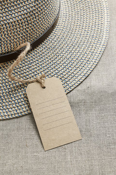 Fedora Hat With Paper Price Label On Jute Background