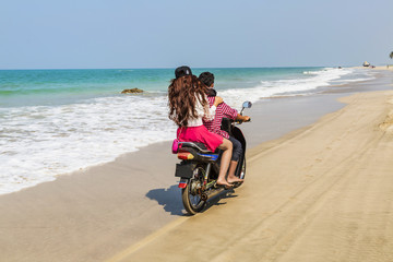 Obraz premium Girl with boy on the motorbike at the Beach in Myanmar, Ngwe beach
