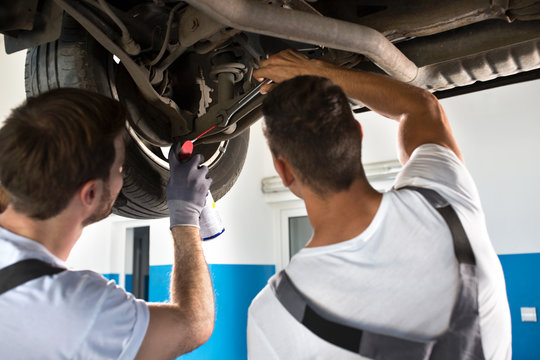 Mechanics working together on car repair