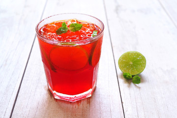 Close up of lime iced tea on a wooden table.