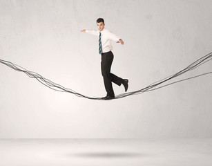 Sales person balancing on drawn ropes