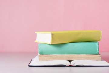 Open book, hardback books on wooden table. Education background. Back to school. Copy space for text.