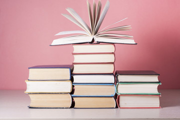 Open book, hardback books on wooden table. Education background. Back to school. Copy space for text.