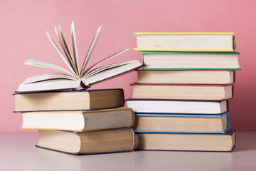 Open book, hardback books on wooden table. Education background. Back to school. Copy space for text.