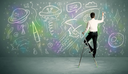 Young businessman drawing rocket