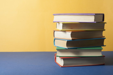 Stack of colorful books. Education background. Back to school. Copy space for text.