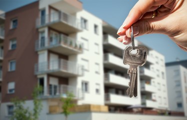 Woman hand holding keys with to house