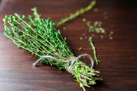 Fresh green bunch of thyme on wooden background