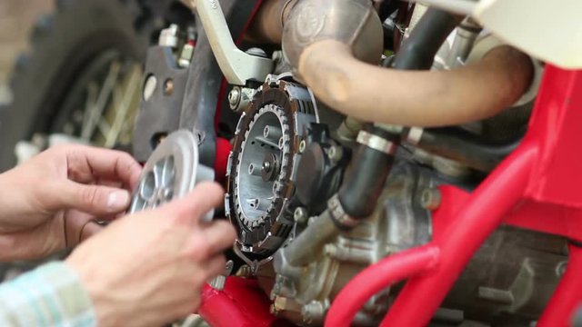 male sportsman repairing his enduro motorcycle