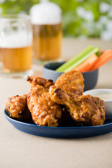 Barbecue hot chicken wings with beers at pub garden
