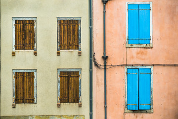 Fototapeta na wymiar closed vintage french window shutters on buildings