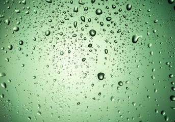 Drops on the glass with a green glow