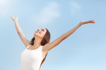 Beautiful young woman with open hands enjoying summer vacation. Summer holidays concept. 