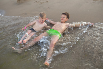 children boys playing on the beach during the day