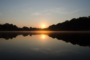 Fototapeta na wymiar Sunrise above the lake in the forest