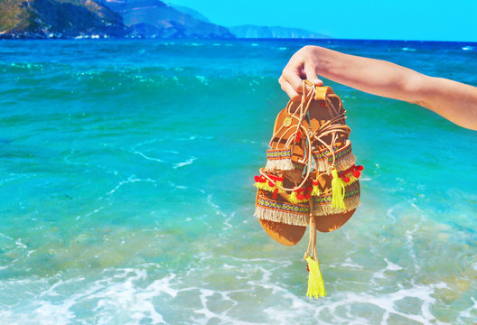 bohemian greek sandals on the beach - summer shoes advertisement