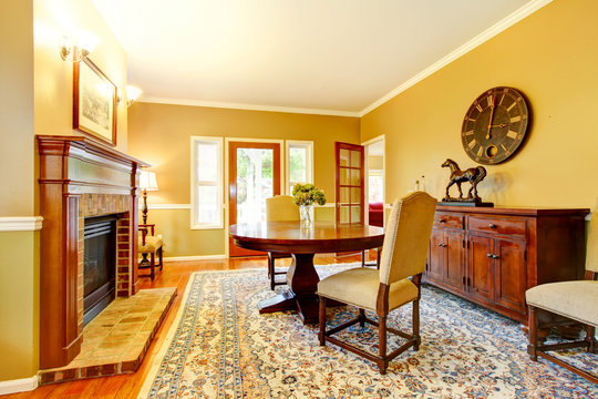 Horse ranch dining room with fireplace and wooden cabinet.