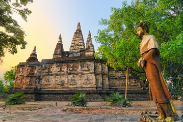 Fototapeta premium Ancient pagoda at Wat Jet Yod is the historic in Chiangmai Thai as landscape background