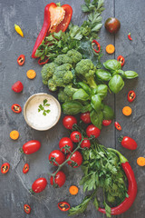 Ingredients for a colorful vegetable salad with a spicy dressing.Top view, vintage toned image, blank space
