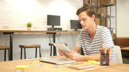 Man in office using Digital tablet PC, creative designer , agency 