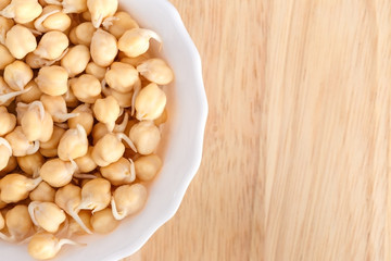 germinated chickpeas in a white bowl - 117591564