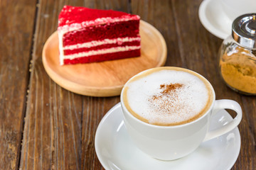 A cup of  coffee and a piece of cake.