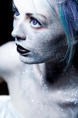 Unusual girl with bright fashion makeup, creative body art on theme space and stars. Looking up