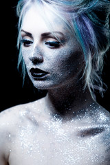 Unusual girl with bright fashion makeup, creative body art on theme space and stars. Looking down