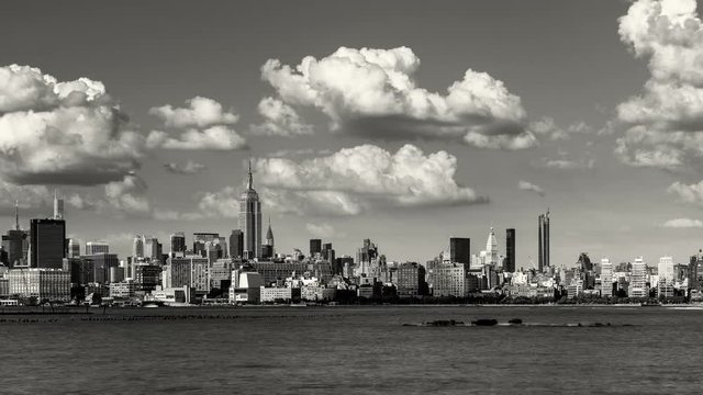 Manhattan Midtown West skyscrapers and Hudson River with passing clouds in Black & White. Cityscape time lapse of a summer afternoon in New York City with view of Midtown and West Village 