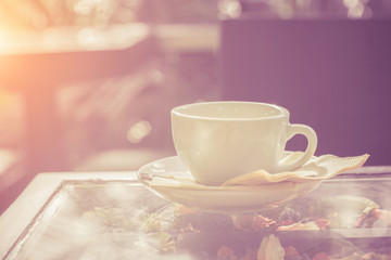 Cup of coffee on table in cafe,White cup of coffee at the cafe interior on the morning.