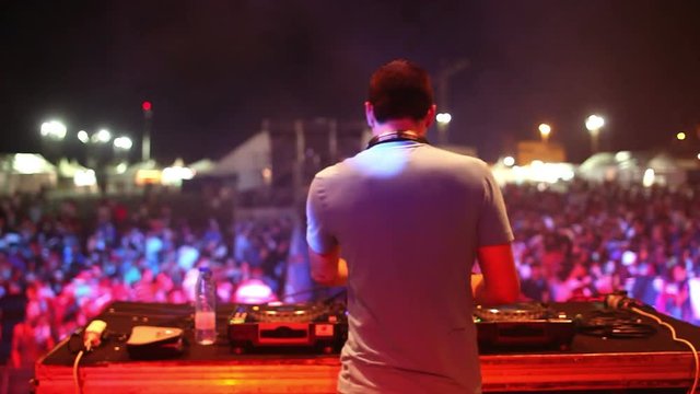 dj at a music event from behind