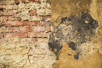 Stone wall texture of grey, brown and red colors. Horizontal color photo.