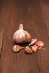 Ripe garlic head on a wooden background