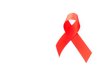 Hand hold red ribbon on white background for AIDs awareness concept