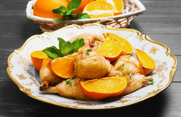 Baked chicken drumstick with baked oranges