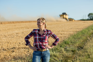 happy female farmer in wheat field