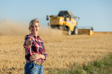 happy female farmer in wheat field