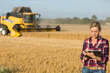 female farmer using electronics - 117598166