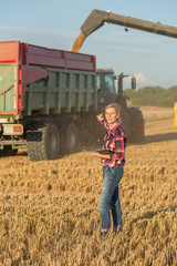 female farmer and combine harvester