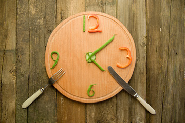 Watch made from vegetables are round cutting Board.