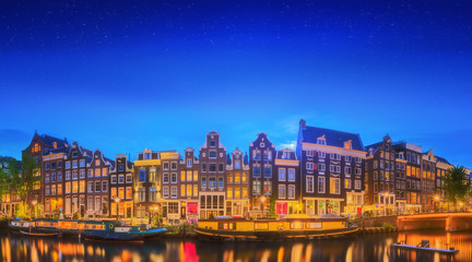 Fototapeta na wymiar Amstel river, canals and night view of beautiful Amsterdam city. Netherlands