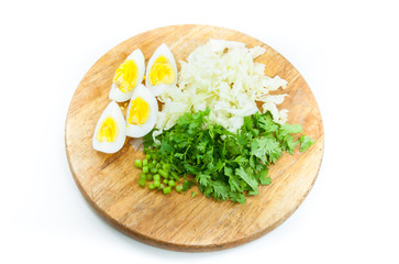 Sliced  egg lettuce Coriander on wooden board on white background