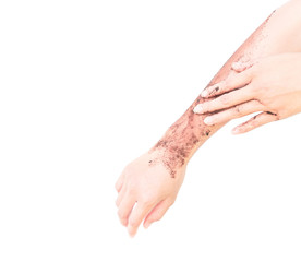 Fototapeta premium Woman's hand with scrub coffee grounds on skin hand and arm, beauty and healthy care concept