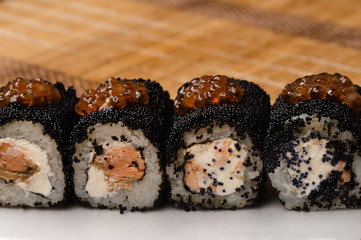 fresh rolls with black caviar on table