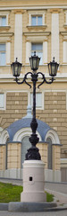 Fototapeta na wymiar Old street lantern at background of vintage luxury building