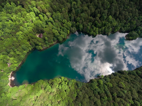 The Biograd lake. Sky with clouds reflection in water. Lush green forest of Bjelasica mountains, Kolasin, Montenegro